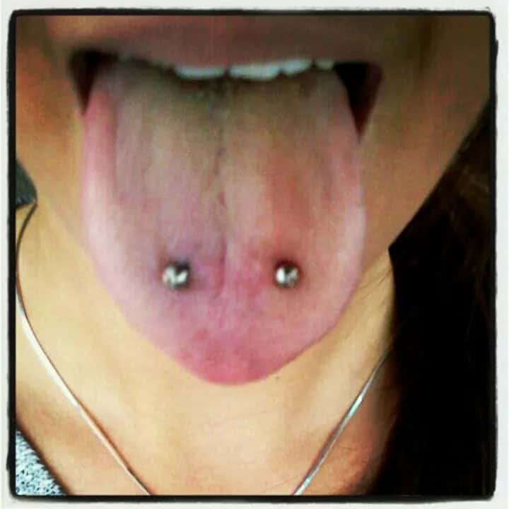 How is a snake eyes piercing done?