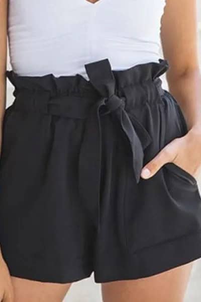 White V Neck Form Fitting Sleeveless Blouse with Mini Black Shorts