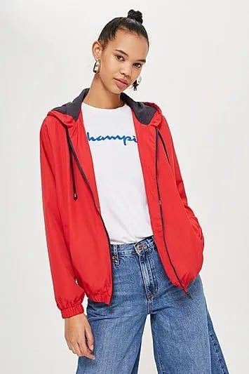 Red Windbreaker with White Print Tee & Flared Jeans