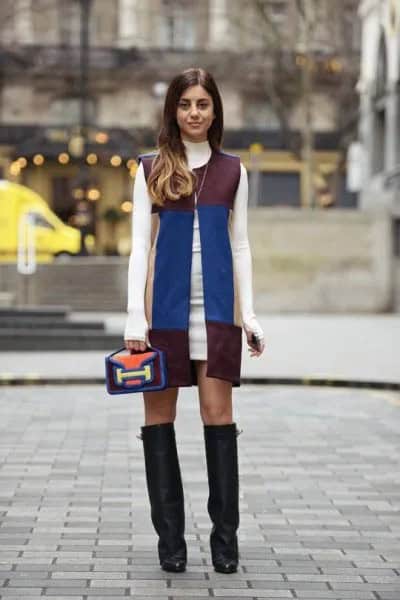 White Sweater Dress with Black and Blue Sleeveless Leather Jacket