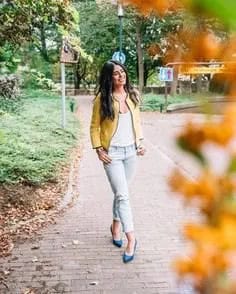 Bomber Jacket with White Scoop Neck Vest Top & Light Blue Jeans