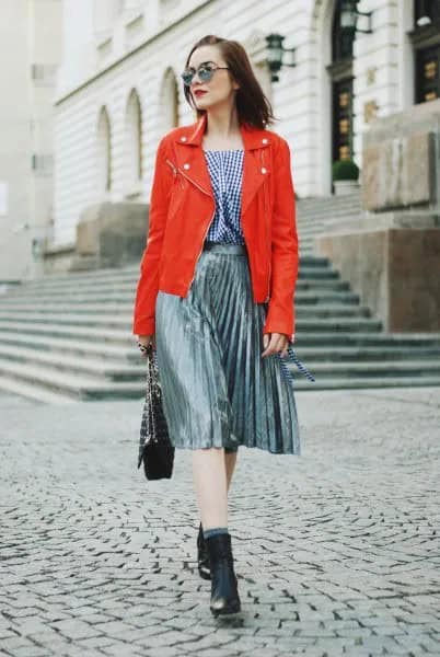 Orange Leather Jacket with Checkered Blouse & Silver Pleated Skirt