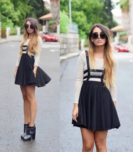 White Long Sleeve T Shirt with Mini Pleated Black Skirt & Ankle Heeled Boots