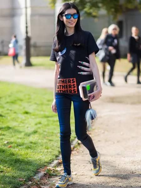 Black Graphic Tee with Dark Blue Skinny Jeans & Yellow and Grey Trail Shoes