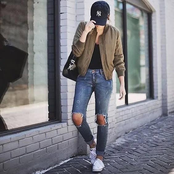 Green Bomber Jacket with Black Scoop Neck Top & Heavily Ripped Jeans